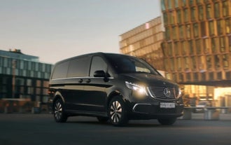 A black van driving in Reykjavik, providing private transfers from Keflavik Airport to the city.