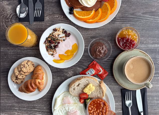 Breakfast spread at Snjófell Restaurant with coffee, fresh bread, and assorted dishes on the table.