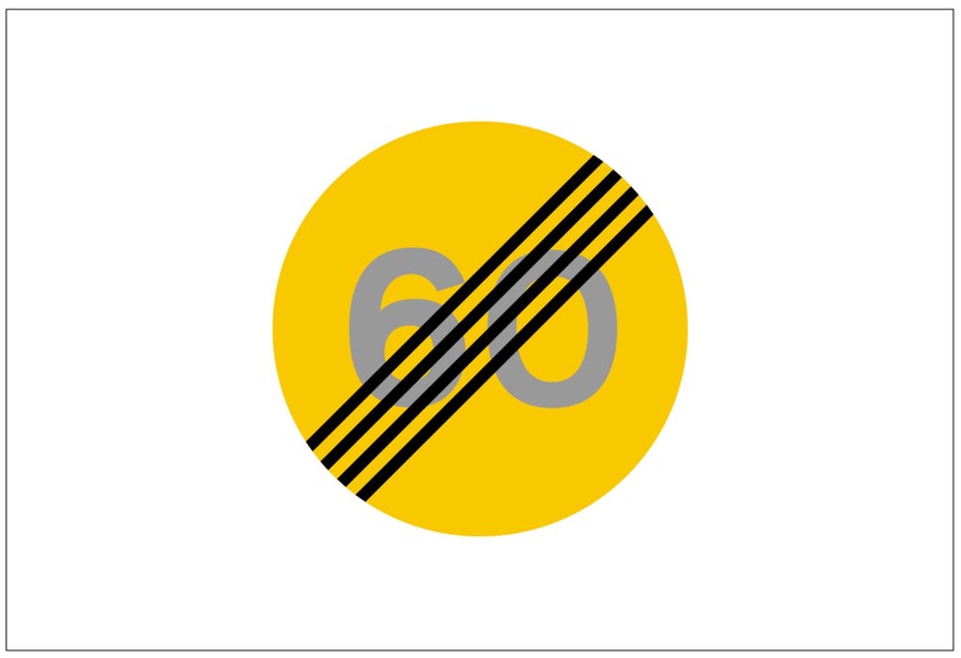 A yellow circular Icelandic road sign with four black lines through the number 60 indicates the end of that speed zone.