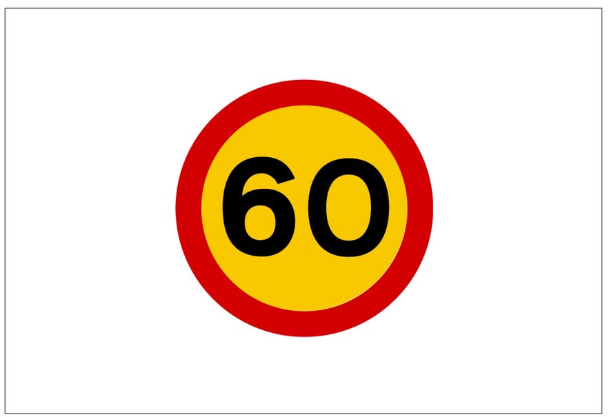 A yellow circular Icelandic road sign with a red border and a black number 60 in the middle indicates the maximum speed allowed is 60 kilometers per hour.