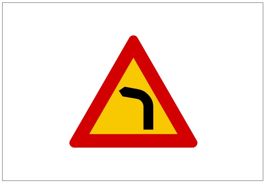 A yellow triangular Icelandic road sign warns drivers that the road curves to the left.