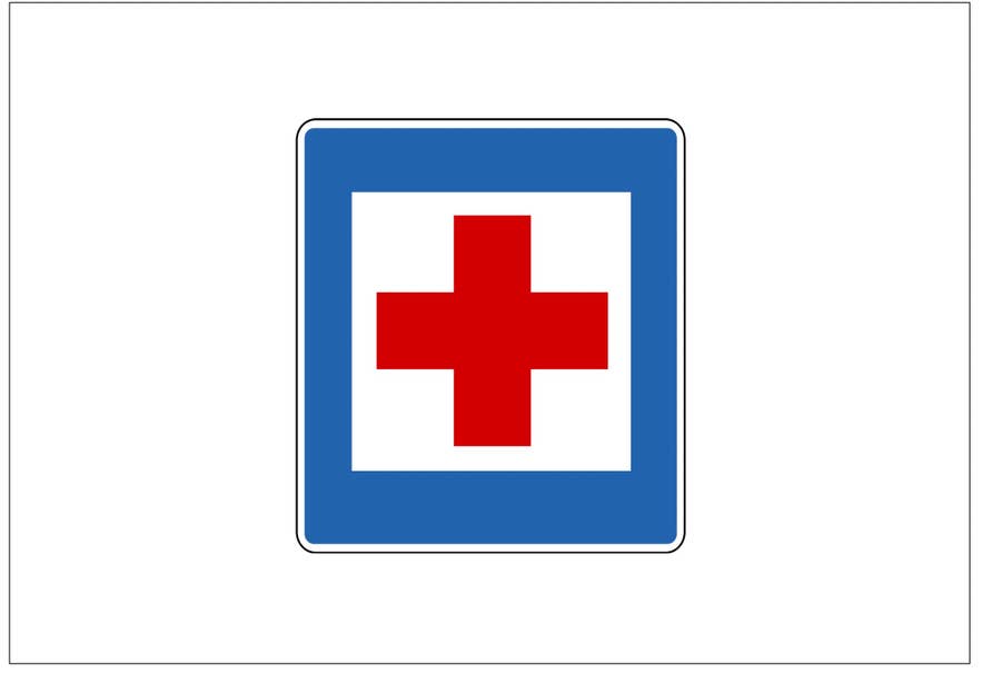 Ein quadratisches Schild mit weißem Hintergrund, blauem Rand und rotem Kreuz in der Mitte zeigt eine Erste-Hilfe-Station an.