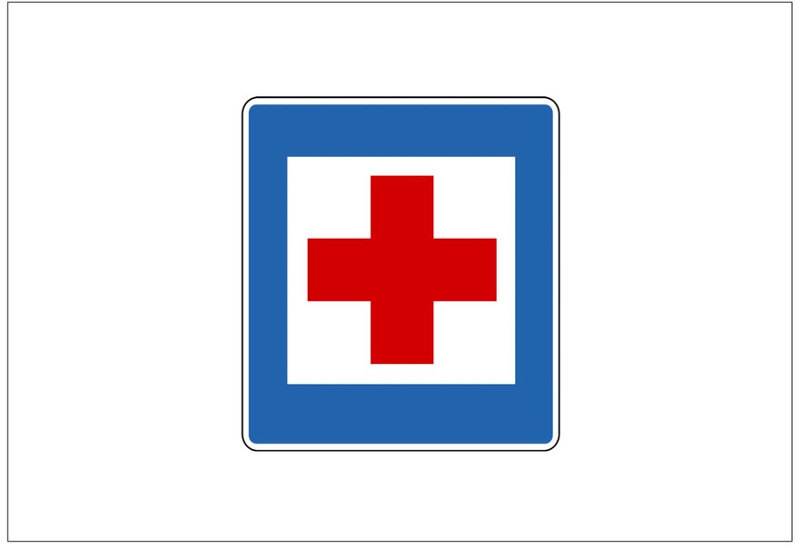 A square sign with a white background, blue border, and red cross in the middle shows indicates a nearby first aid station.