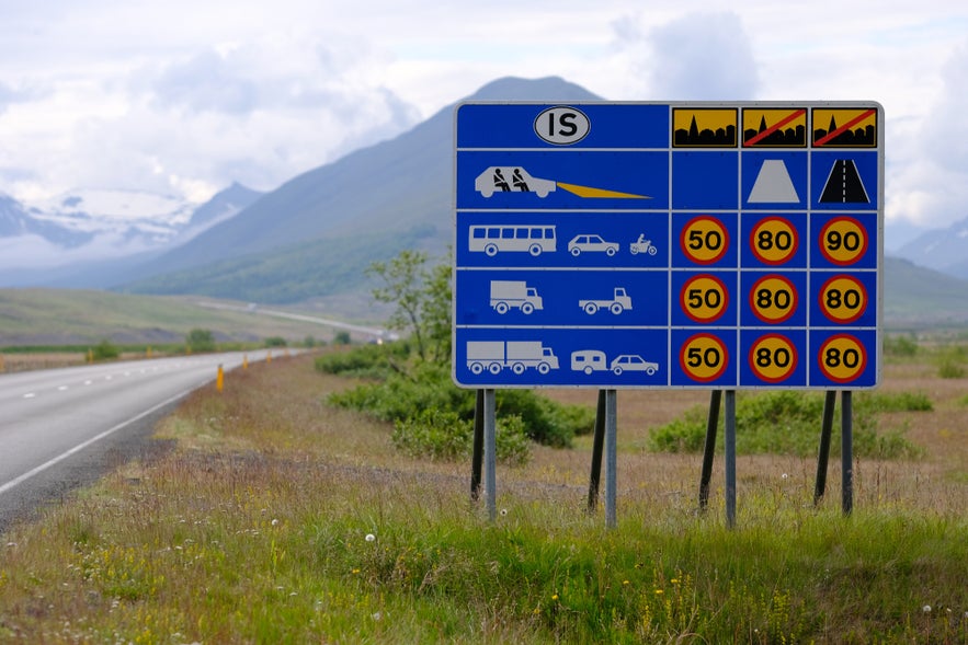 Icelandic road signs follow recognizable patterns in shape and color.
