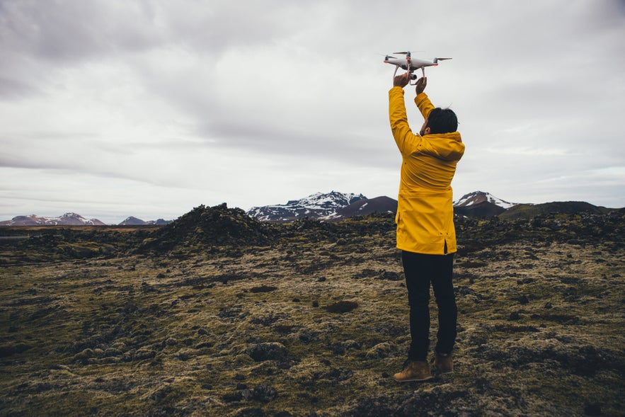 Drone operator preparing for aerial shots in the Highlands while flying drones in Iceland’s wild terrain.