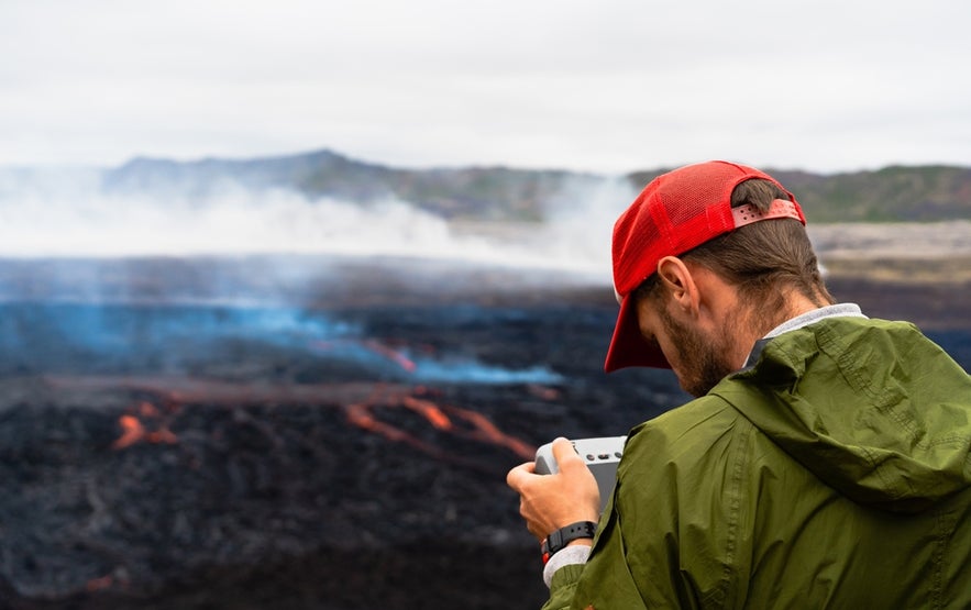 Capturing aerial footage of volcanic lava and smoke at Fagradalsfjall while flying drones in Iceland.