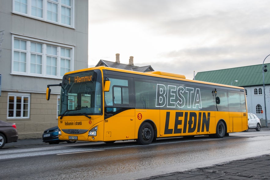 Straeto bus driving through downtown Reykjavik, highlighting convenient public transportation in Iceland.