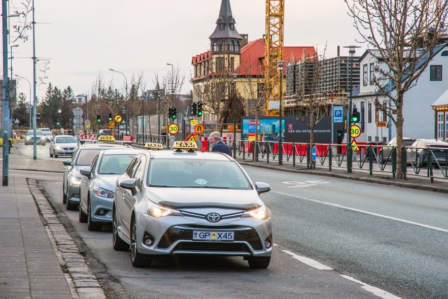 Taxi cars waiting for passengers in downtown Reykjavik, providing convenient city transportation in Iceland.