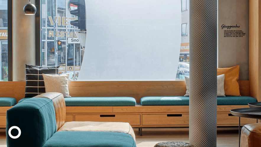 Cozy lounge area with modern seating and large windows inside CenterHotel Laugavegur in Reykjavik.