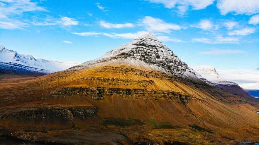 The best places to visit in East Iceland include Bulandstindur Mountain with its pyramid shape and snow-capped peak.