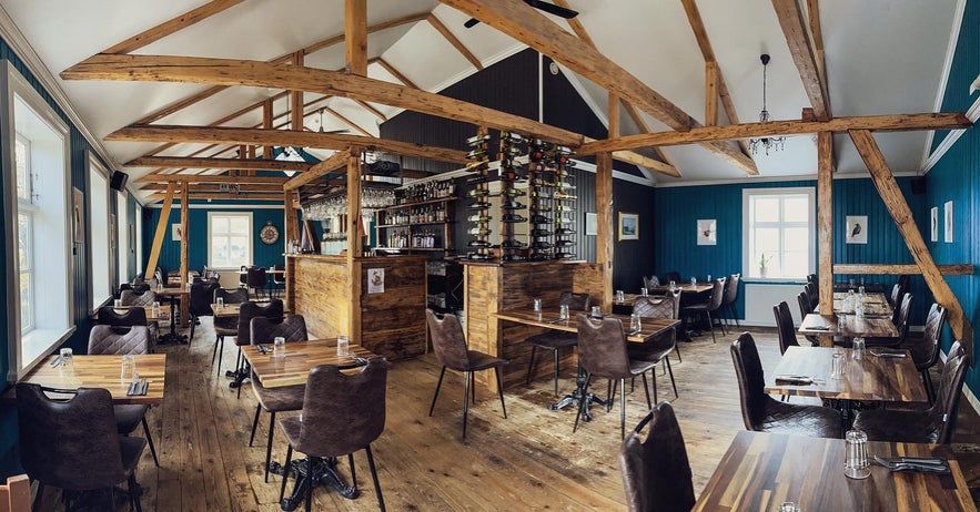 Rustic wooden dining room interior at Sudur-Vik Restaurant in Iceland.