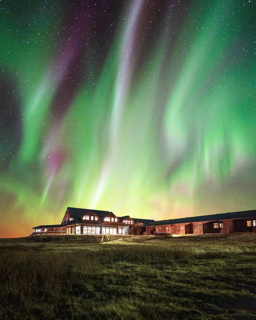 Northern lights in Iceland dancing above Hotel Ranga, a countryside retreat known for aurora viewing.