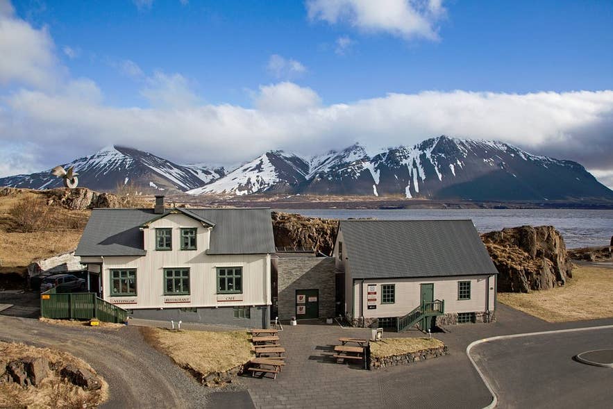 The Settlement Center restaurant in Borgarnes, Iceland, with stunning mountains in the background.
