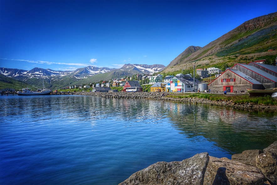 Siglufjordur in North Iceland is one of the hidden gems in Iceland with colorful houses, mountain views, and a scenic harbor.