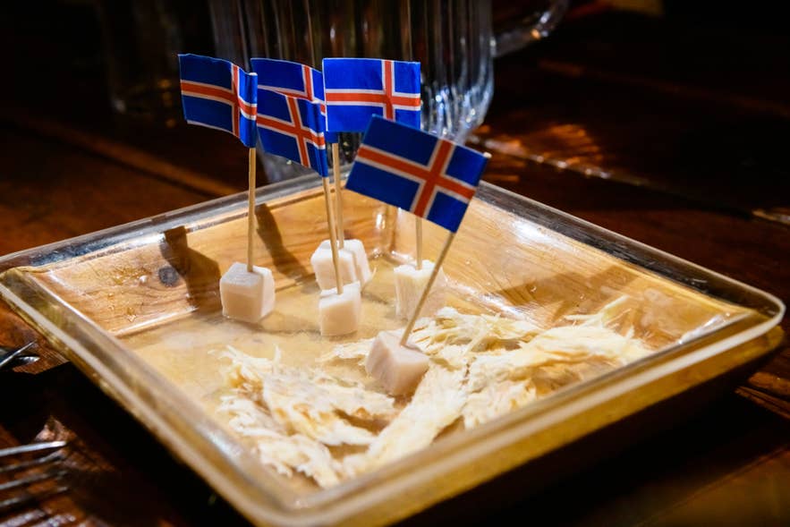 A plate of hakarl and dried fish for tasting. A plate of hakarl and dried fish for tasting.