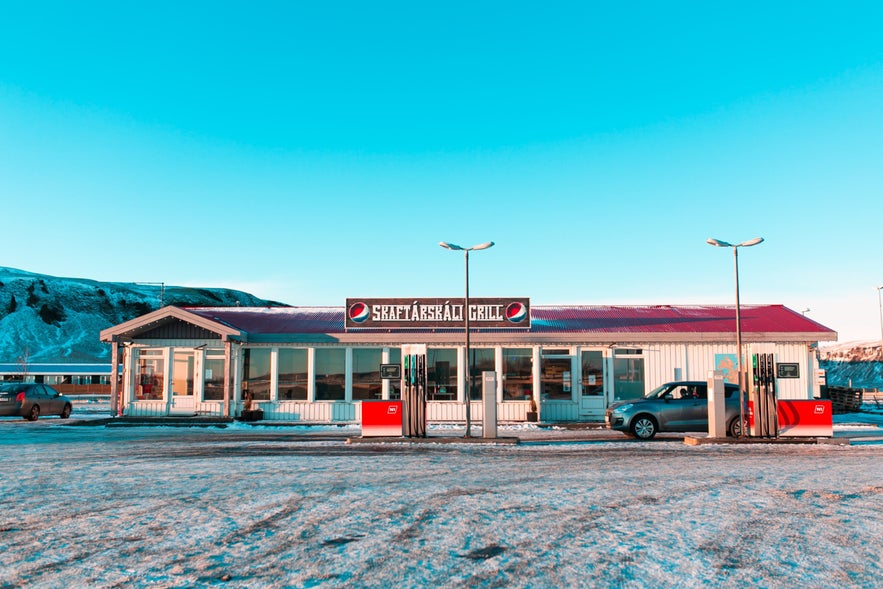 N1 gas station and Skaftarskali grill in south Iceland with snowy landscape and red-roof building