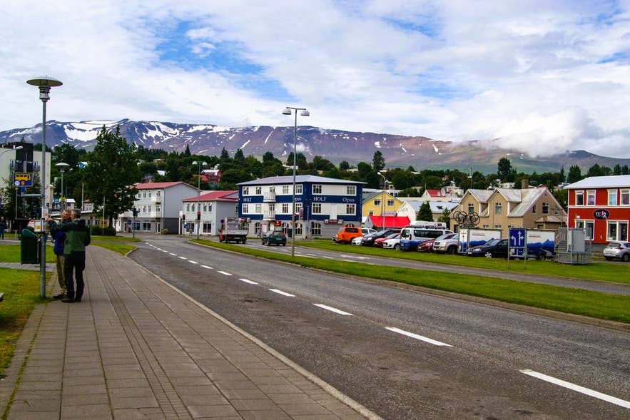 Vista de la calle en Akureyri con coches aparcados, mostrando opciones fuera de Reikiavik en Islandia.