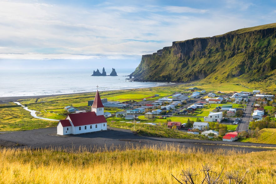 Scenic view of Vik village and Reynisdrangar sea stacks in South Iceland, a top spot for travelers seeking where to stay in Iceland.