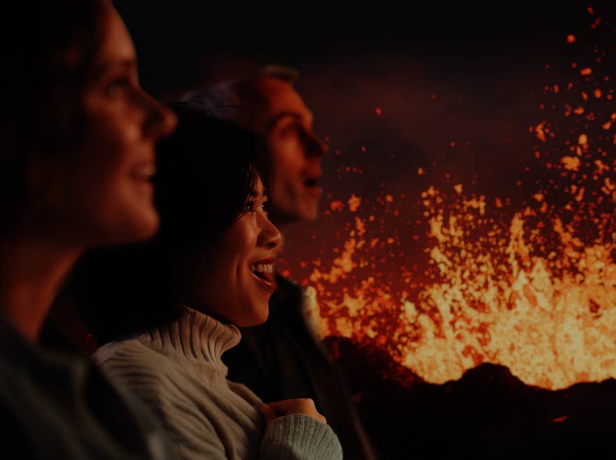 Group of people amazed watching a volcanic eruption simulation inside Volcano Express in Reykjavik.