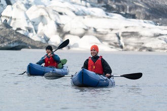 Two kayakers paddling in front of Flaajokull Glacier in Iceland.