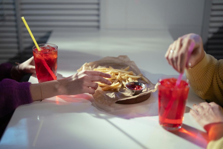Table with fries and drinks at one of the affordable restaurants in Reykjavik. Table with fries and drinks at one of the affordable restaurants in Reykjavik.