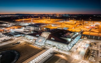 Overhead photo of the Keflavik Airport glowing under the night sky.