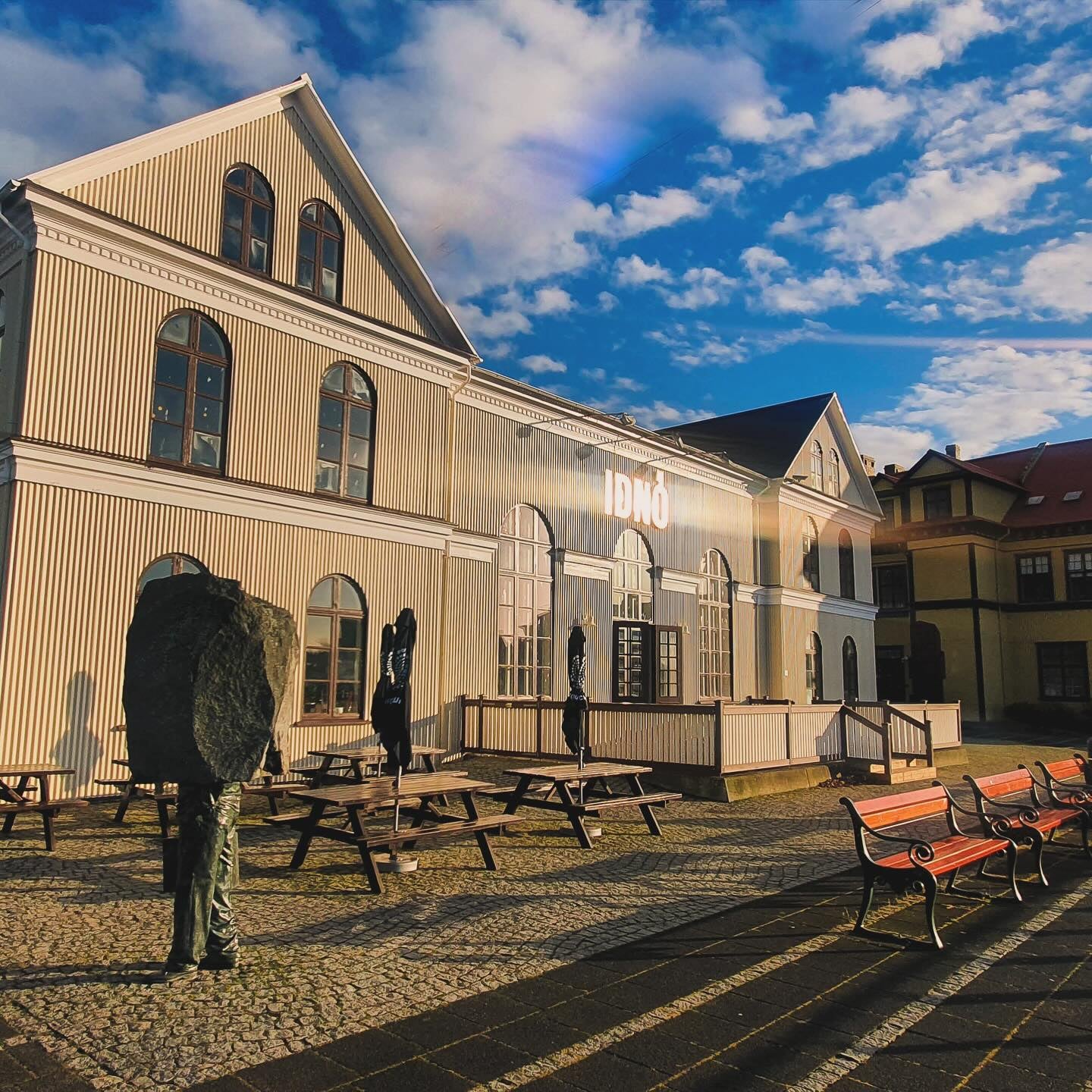 Iðnó cultural house in Reykjavik with outdoor seating and historic architecture.