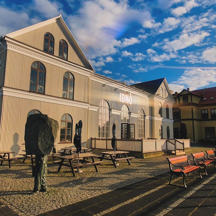 Iðnó cultural house in Reykjavik with outdoor seating and historic architecture. Iðnó cultural house in Reykjavik with outdoor seating and historic architecture.