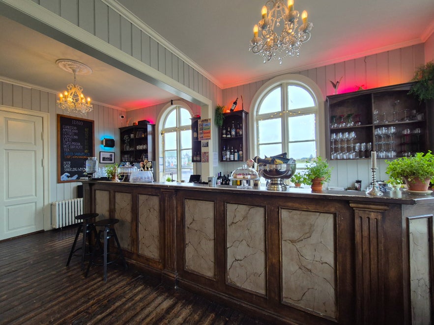 Iðnó Café bar with chandeliers, wooden counter, and cozy interior in Reykjavik