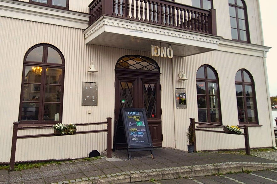 Historic entrance of Iðnó Café in Reykjavik with event sign outside
