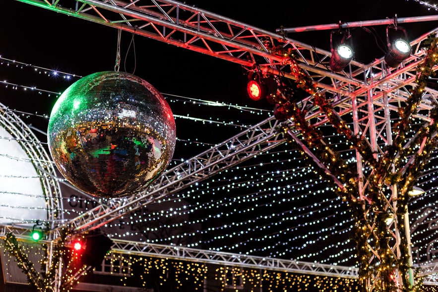 Sparkling disco ball and festive lights in Reykjavík at night, capturing the joyful spirit of Christmas in Iceland.