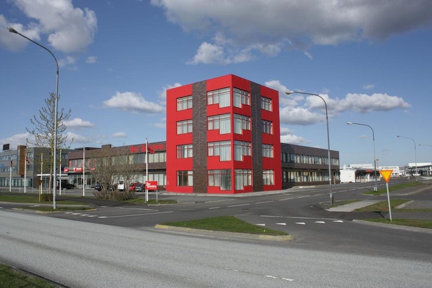 Nordurey Hotel Reykjavik Road, a red roadside building with large windows, located in Hafnarfjordur, Iceland.