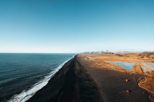 Aerial view of Iceland’s black sand beach stretching along the South Coast in summer