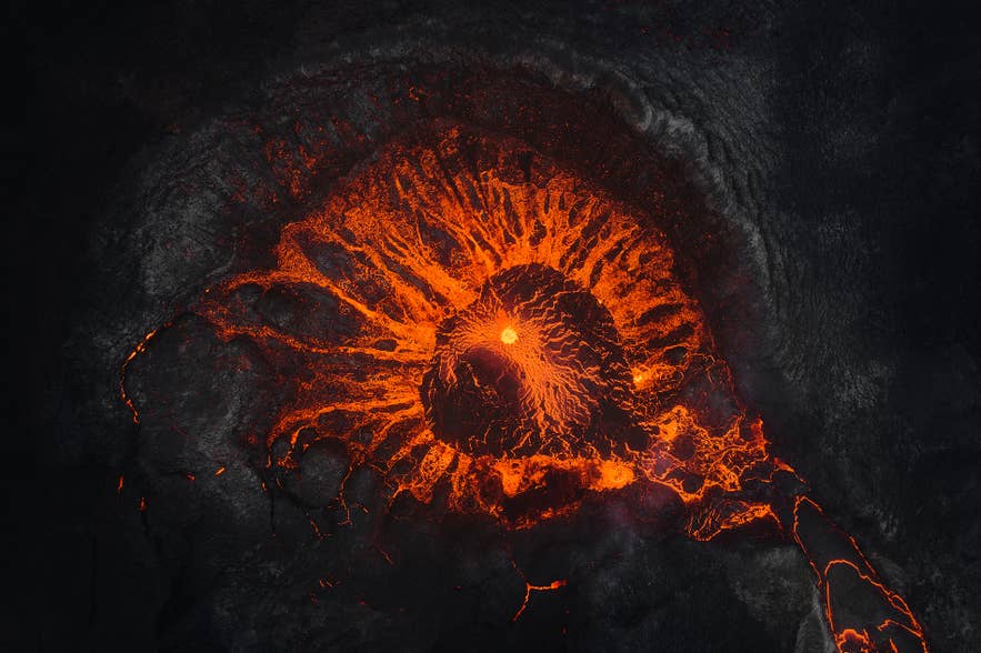 Aerial view of an active crater with glowing lava flow during a Volcano Express in Harpa Concert Hall.