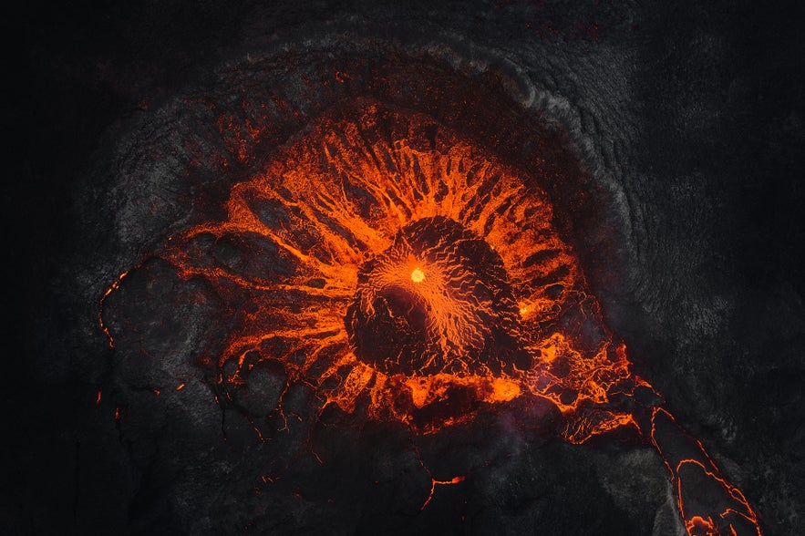 Aerial view of an active crater with glowing lava flow during a Volcano Express in Harpa Concert Hall.