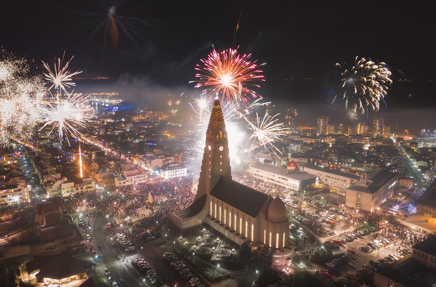 New Year fireworks above Hallgrimskirkja and the city skyline at night.