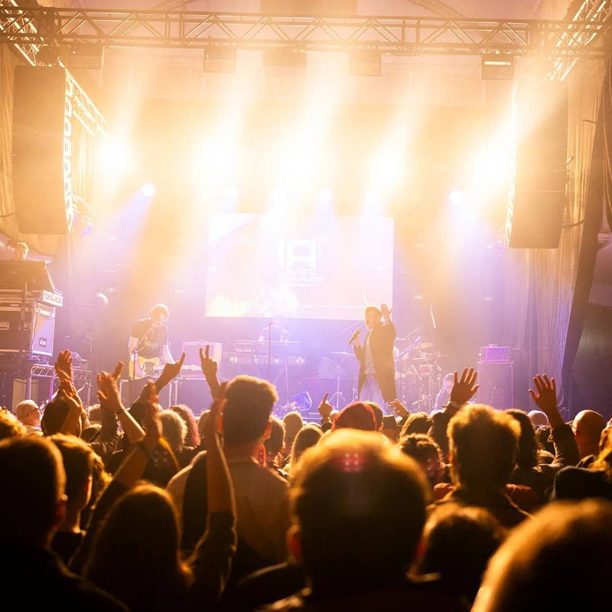 Live concert with a singer and a band performing on stage during the Iceland Airwaves Festival in Reykjavik.