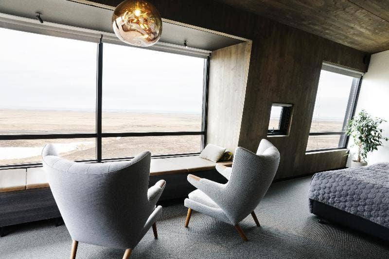 Modern room at Fosshotel Glacier Lagoon with cozy seating and panoramic views of Iceland’s vast landscapes.