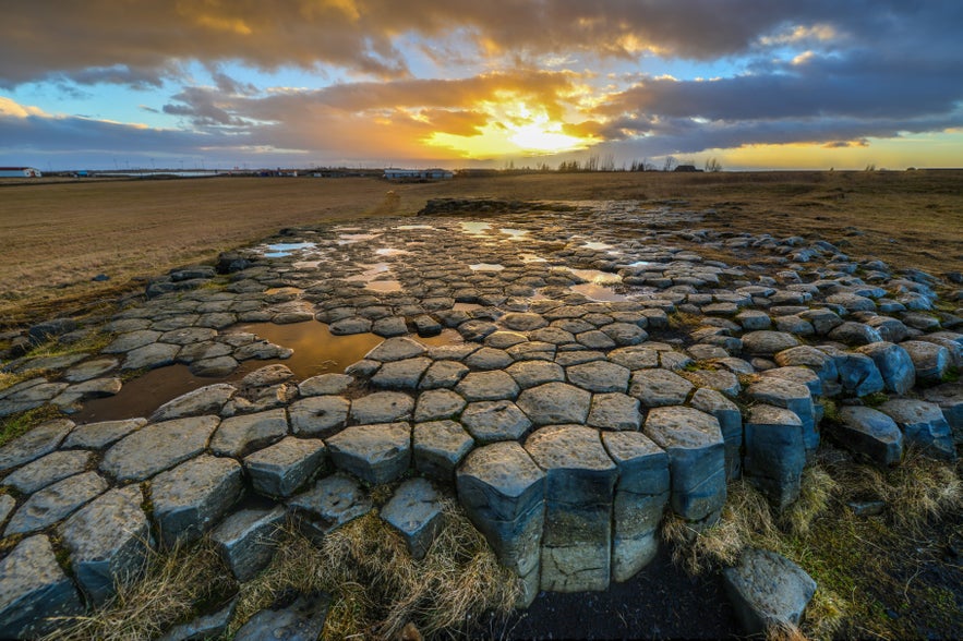 Basalt rock formations at Kirkjugolf in Iceland during sunset.