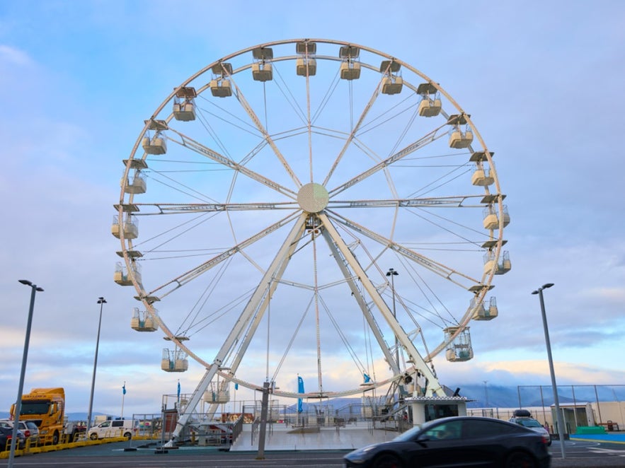 Ferris wheel at the Old Harbor in Reykjavik on a sunny day with blue sky.
