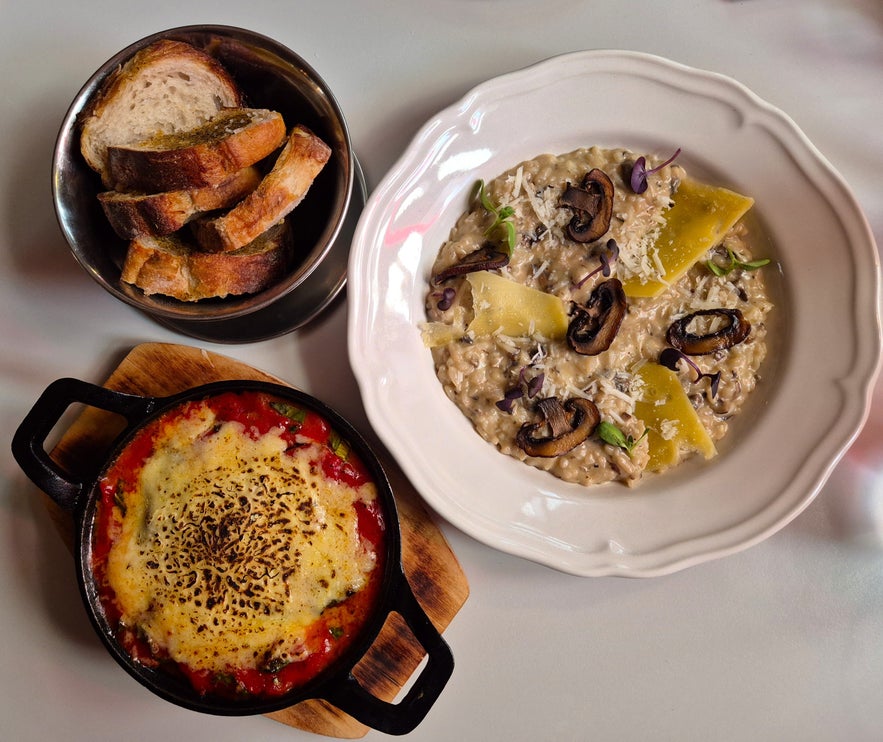 Mushroom risotto and baked eggplant parmigiana served with fresh bread at Litli Barinn in Reykjavik.