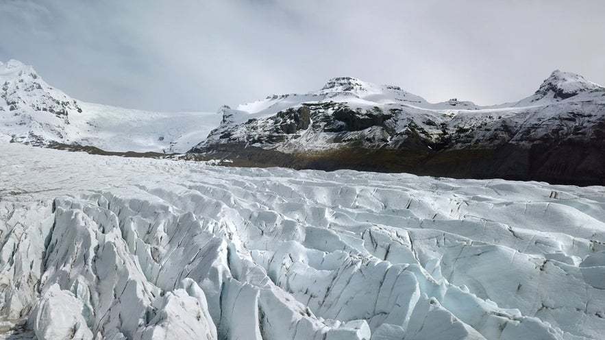 Svinafellsjokull Glacier is an outlet glacier of the larger Vatnajokull ice cap in Iceland, known for its dramatic ice formations and stunning views of the surrounding mountains.