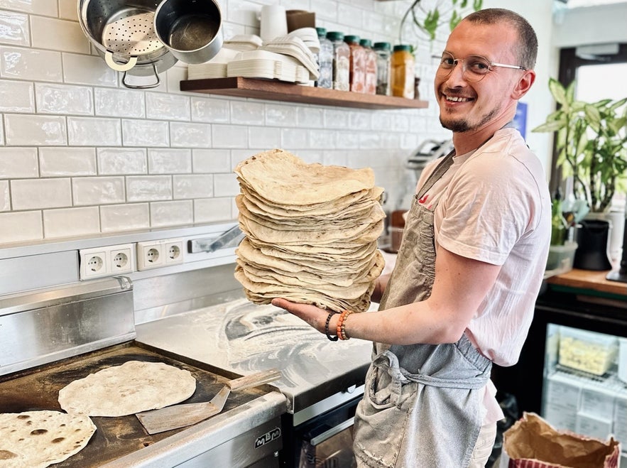 Chef at Chickpea restaurant in Reykjavik preparing home made wraps or bread.