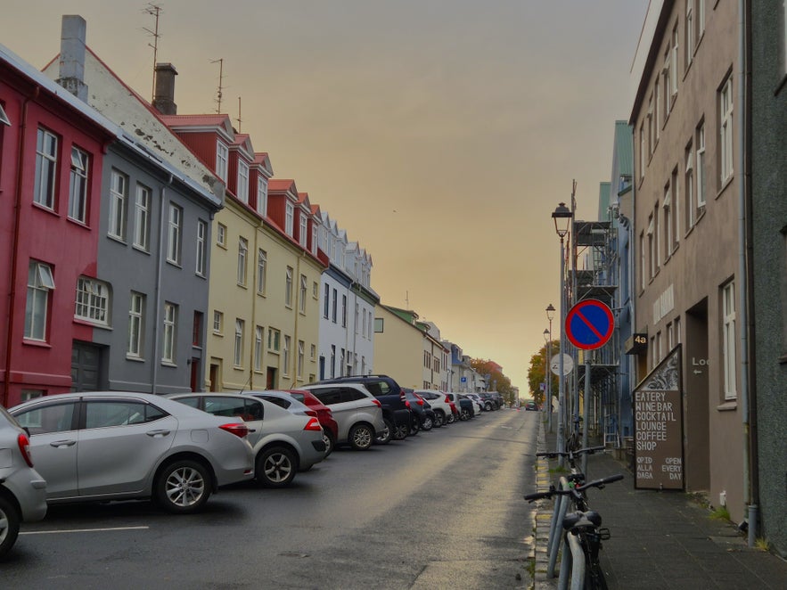 Colorful Ranargata street in Reykjavik with parked cars and evening light near Litli Barinn.