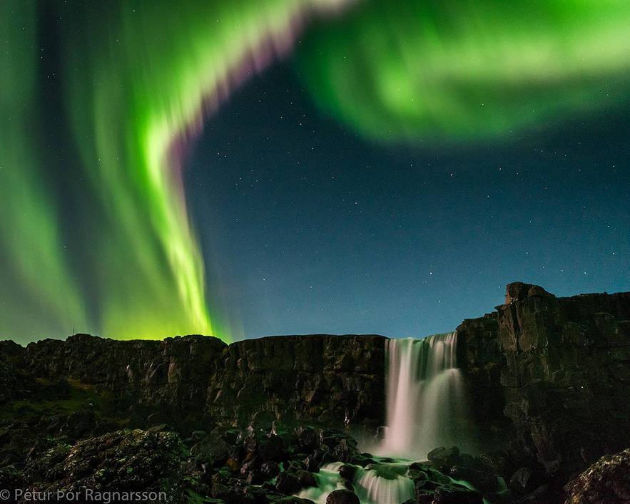 Northern Lights over a waterfall in Iceland