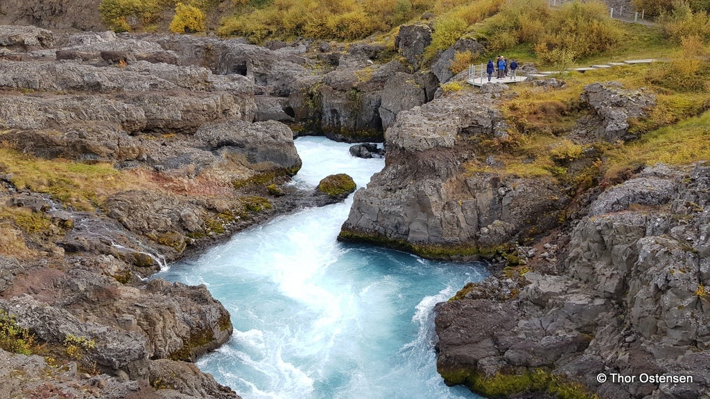 Barnafossar reveals its hidden charm as the cascading water gracefully carves its way through the rugged Icelandic landscape.