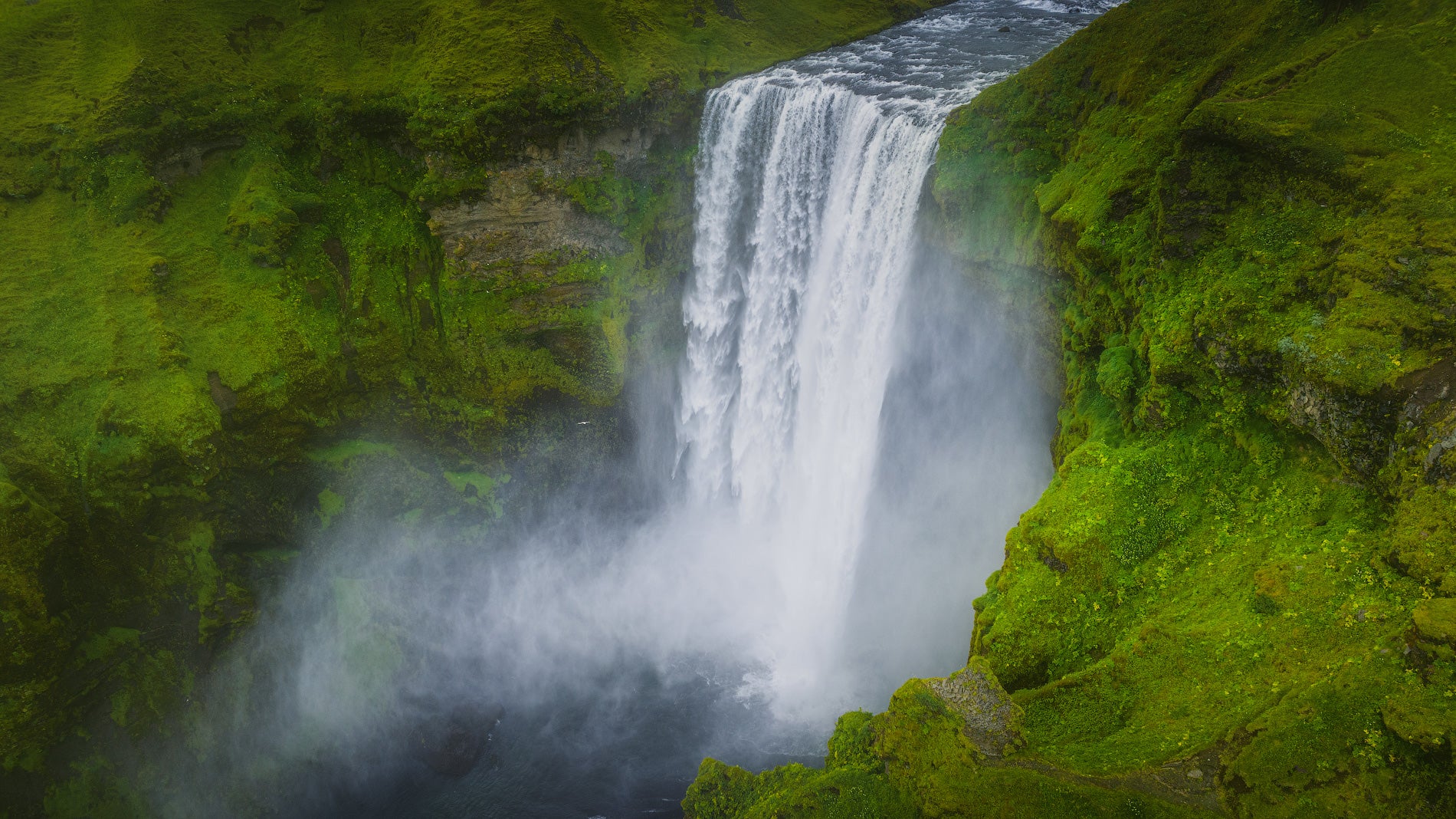 An overhead view of the rushing cascade of Skogafoss Waterfall in Iceland's South Coast.