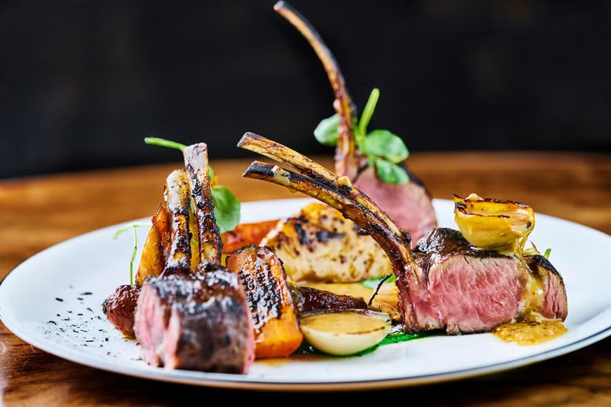 Gourmet lamb dish with seasonal Icelandic ingredients on elegant plate served at Apotek Restaurant in Reykjavik.