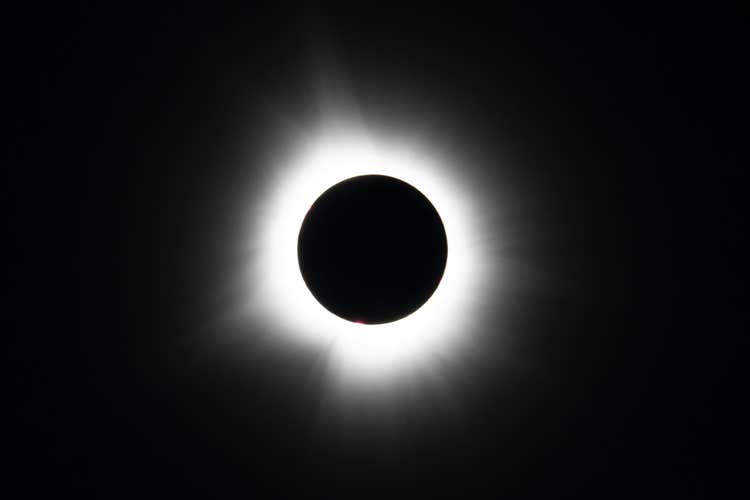 The sun's corona shines aorund the mooon on a solar eclipse tour in Iceland.