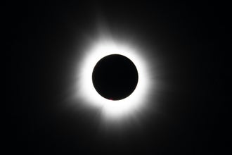 The sun's corona shines aorund the mooon on a solar eclipse tour in Iceland.